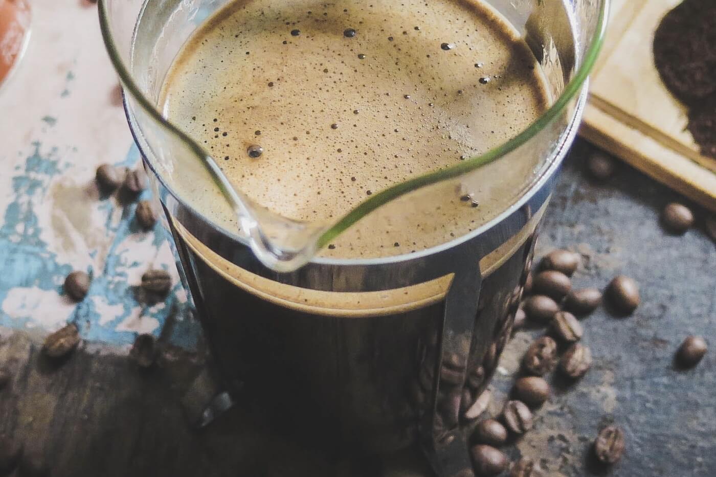French press brewer with freshly brewed coffee